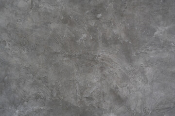 Textured gray concrete wall with a rough, industrial finish, ideal for modern design backgrounds.