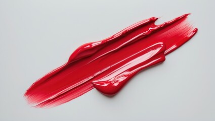 Lipstick brush stroke or makeup smear. Isolated swatch on background. Creamy texture. Sample of bright red cosmetic product.