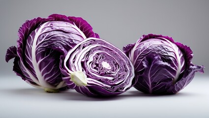 Fototapeta premium Two red cabbages and a slice separated on a white background. Clipping path.