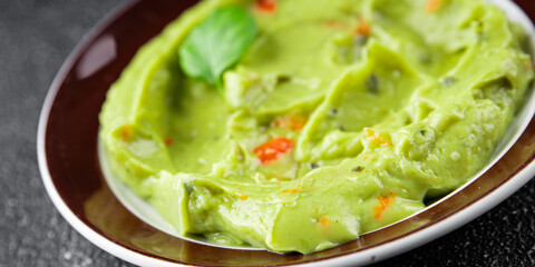 Guacamole dip avocado sauce vegetables dish organic fresh tasty gourmet food background on the table rustic food top view copy space 
