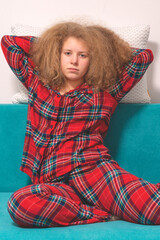 girl sitting with pillow on the couch. beautiful girl  sitting on the couch. Concept of a good, sound sleep. young girl with pillows in room