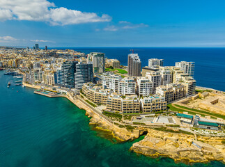 Fototapeta premium Drone aerial view of Sliema city, coast road, waterfront, buildings. Malta island