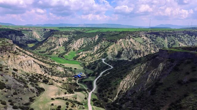 Aerial Video Kula Geopark Fairy Chimneys Rising from Volcanic Rock Formations Under Cloudy Sky