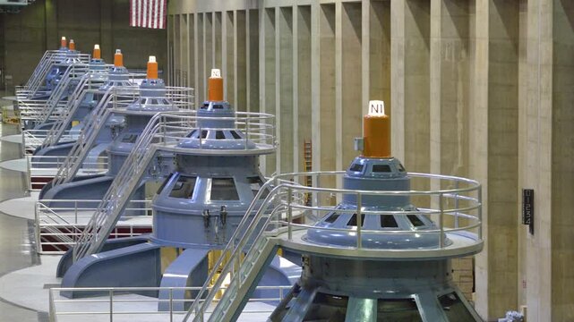Large power generators operate within the Hoover Dam, illustrating the impressive engineering and infrastructure that harnesses hydroelectric power in the US.