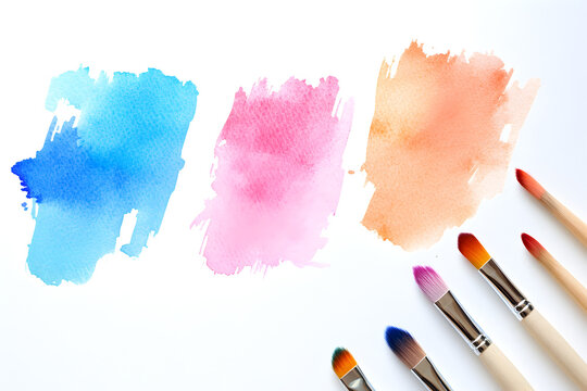 Creative watercolor strokes displayed on paper alongside various brushes for artistic expression during an afternoon art session