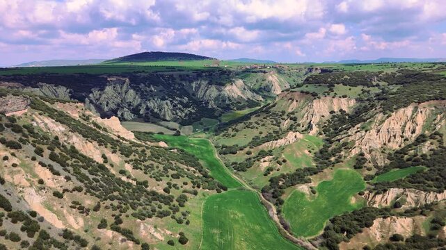Aerial Video Kula Geopark Fairy Chimneys Rising from Volcanic Rock Formations Under Cloudy Sky