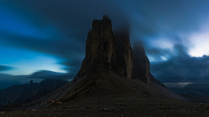 frontal view of tre cime di lavaredo in italy in the Dolomites in autumn after dark at blue hour....