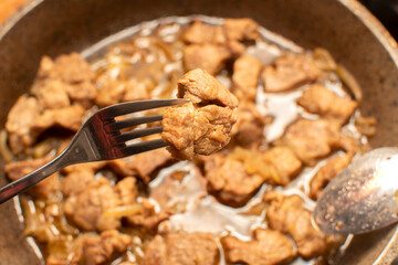 Fried meat on a fork