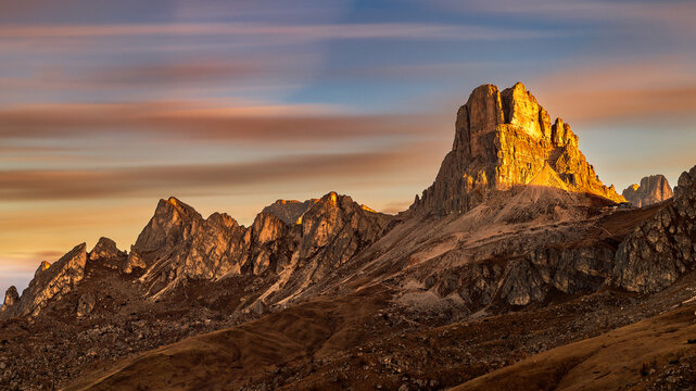 The Passo di Giau mountain pass in the Italian Dolomites. Panoramic view of Passo di Giau at sunrise in autumn. View of the Ra Gusela mountain.