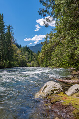 Majestic mountain creek with rocky background in Vancouver, Canada, North America. Day time on July 2024.