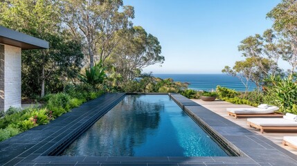 Elegant Modern Infinity Pool Overlooking Scenic Ocean View Surrounded by Lush Greenery and Tranquil Landscape