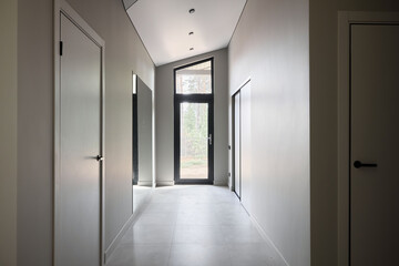A Stunning Modern Hallway Featuring Large Windows and a Contemporary Minimalist Design
