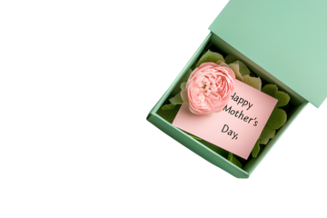 A photograph of an open green gift box with a flowers inside and a card that reads "Happy Mother's Day," set against a transparent background