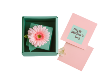A photograph of an open green gift box with a flower inside and a card that reads "Happy Mother's Day," set against a transparent background