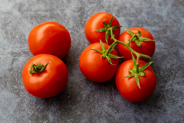 Ripe red tomatoes on wooden background.