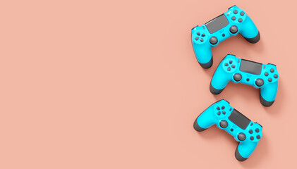 Realistic blue video game joysticks or gamepads on pink background © Vasyl Onyskiv