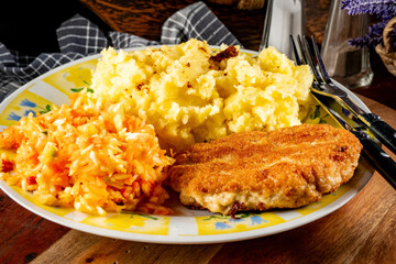 Minced chicken cutlet served with mashed potatoes and salad.