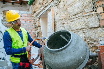 Worker working with a concrete mixer.