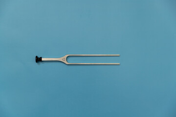 tuning fork C 128 on a white background with gradation