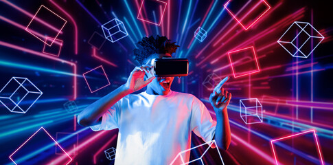 Smart teenager wearing VR glasses and excited about geometric shape. African gamer wearing casual...