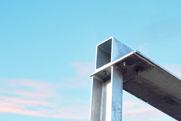 Metal beam structure against clear blue sky highlights modern construction and design