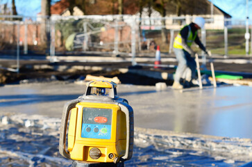 Rotating laser level set on construction site for floor slab concrete pour