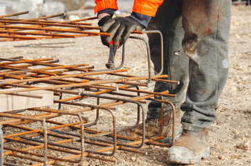 Steel fixer assembling steel rebar structures at construction site