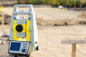 Surveying equipment total station on construction site with a clear focus on ground measurements