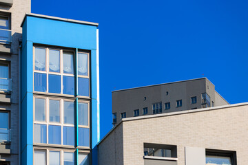 City view on a sunny day. Modern houses against the blue sky.