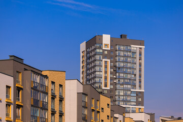 City view on a sunny day. Modern houses against the blue sky.