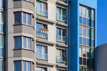 Obraz premium City view on a sunny day. Modern houses against the blue sky.