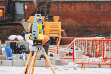 Construction equipment and surveying tools on building site