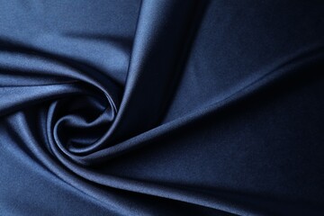 Blue crumpled silk fabric as background, top view