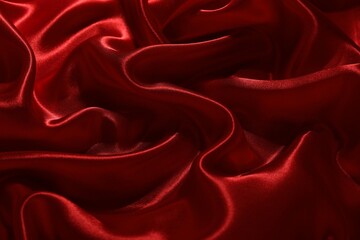 Fototapeta premium Red crumpled silk fabric as background, top view