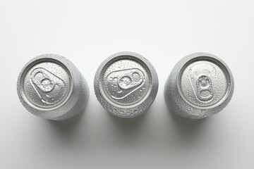 Many different tin cans on light background, top view