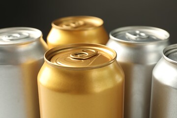 Many tin cans on grey background, closeup