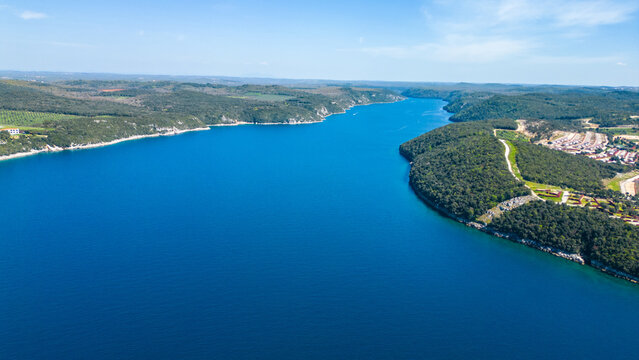 Aerial photo of the stunning Limski Kanal and Camping Koversada near Vrsar, Croatia. The landscape features lush greenery, crystal-clear turquoise waters, and winding coastline &mdash; a true Adriatic