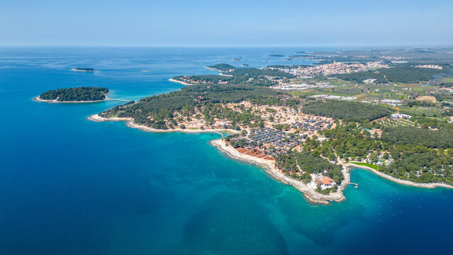 Aerial photo of the stunning Limski Kanal and Camping Koversada near Vrsar, Croatia. The landscape features lush greenery, crystal-clear turquoise waters, and winding coastline &mdash; a true Adriatic