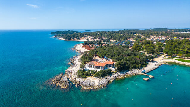 Aerial photo of the stunning Limski Kanal and Camping Koversada near Vrsar, Croatia. The landscape features lush greenery, crystal-clear turquoise waters, and winding coastline &mdash; a true Adriatic