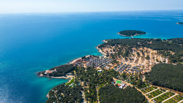 Aerial photo of the stunning Limski Kanal and Camping Koversada near Vrsar, Croatia. The landscape features lush greenery, crystal-clear turquoise waters, and winding coastline &mdash; a true Adriatic