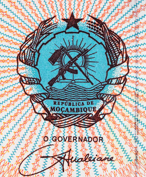 Fragment of a Mozambique 50000 Meticais banknote with the coat of arms of the republic with the image of an AK-47. Mozambique money
