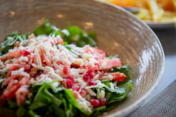 Pomegranate salad. fresh greens and delicious cheese
