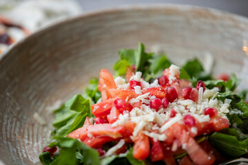 Pomegranate salad. fresh greens and delicious cheese