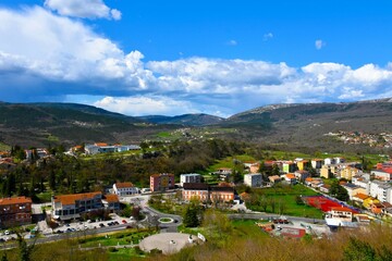 View of forest covered hills and the town of Buzet in Istria, Croatia and white clouds in the sky
