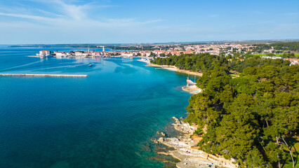 Obraz premium Aerial view of Poreč (Porec), Croatia, showcasing the charming old town, vibrant coastline, and the nearby island of Sveti Nikola. The stunning Zelena Laguna area adds to the beauty turquoise waters