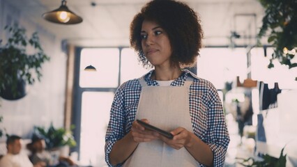 Waitress bringing bill to guest in coffee shop, professional service moment