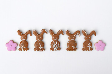 Romantic decorated Easter gingerbread cookies in a shape of bunny and flower, white background