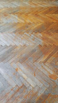 A wooden floor with a herringbone pattern on it