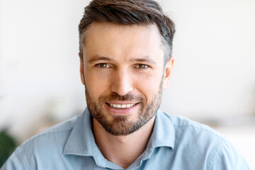 Obraz premium Successful Entrepreneur. Closeup Portrait Of Handsome Young Businessman Smiling At Camera, Posing Indoors, Free Space