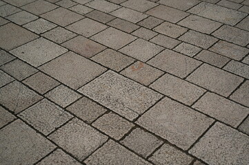 grey geometric paving stones close up, grey geometric tile surface 